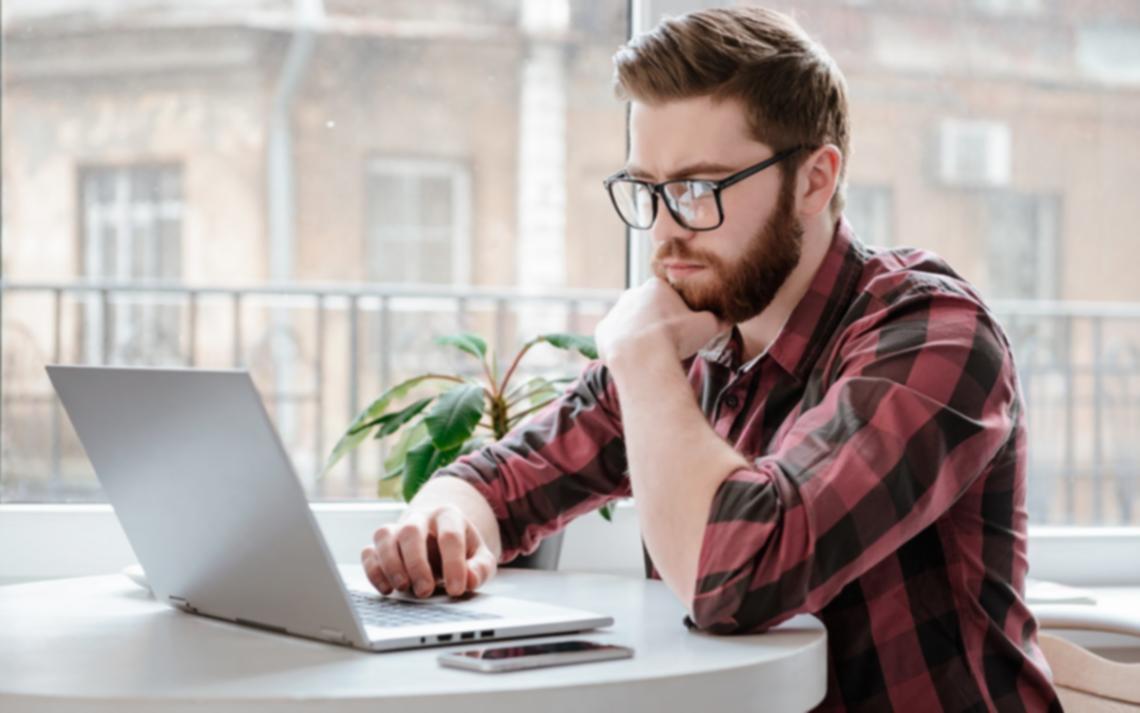 Profesional trabajando en planificación presupuestaria con documentos y dispositivos digitales